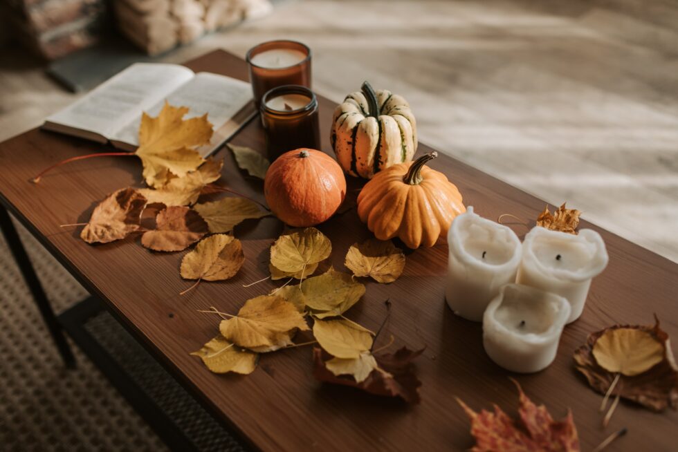 Cute fall decorated coffee table with laminate flooring in the background.